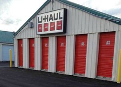 A U-haul storag facility in Columbus that was painted by our company with red garage doors and beige siding.
