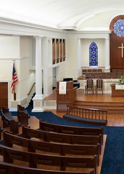 the painted interior of a church with cream colored walls and cathedral ceilings