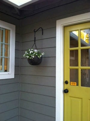 exterior of grey home with a yellow door Exterior of grey home with a yellow door, expertly painted by the Modern Painting team.