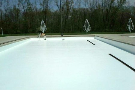 A large commercial pool painted white after pool painting by Modern Painting