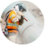 Modern Painting worker sand blasting an industrial pipe