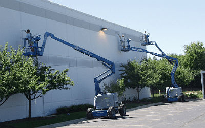 modern painting workers painting the exterior of a commercial building