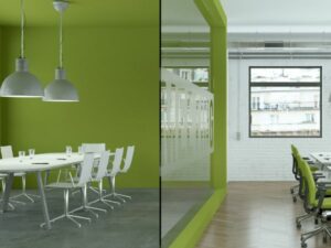 A vibrant green office with a large meeting table