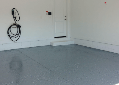 a garage with a gray epoxy coating on the floor
