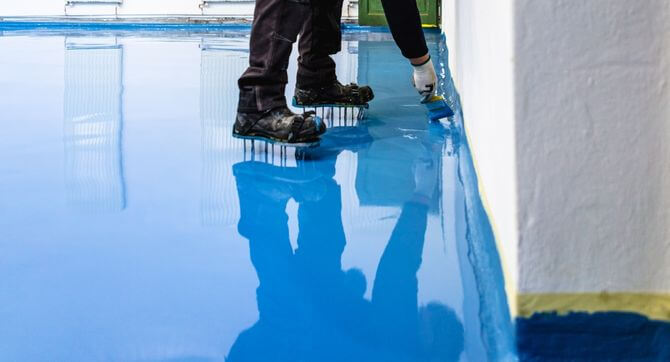 hero a worker expertly applying an epoxy floor in Newark, Ohio