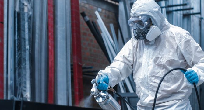 hero an industrial painter expertly applying an even coating in an industrial park