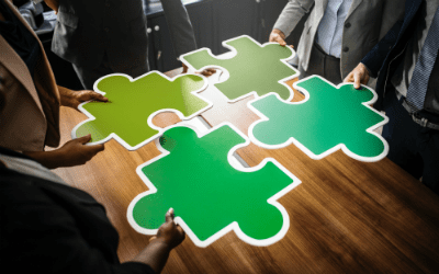 coworkers holding up paint swatches in shades of green