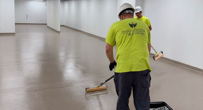 Modern Cards a worker expertly applying an epoxy floor in Newark, Ohio